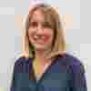 Dr Hannah Levis a blonde lady smiling in a navy blouse