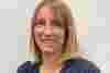 Dr Hannah Levis a blonde lady smiling in a navy blouse