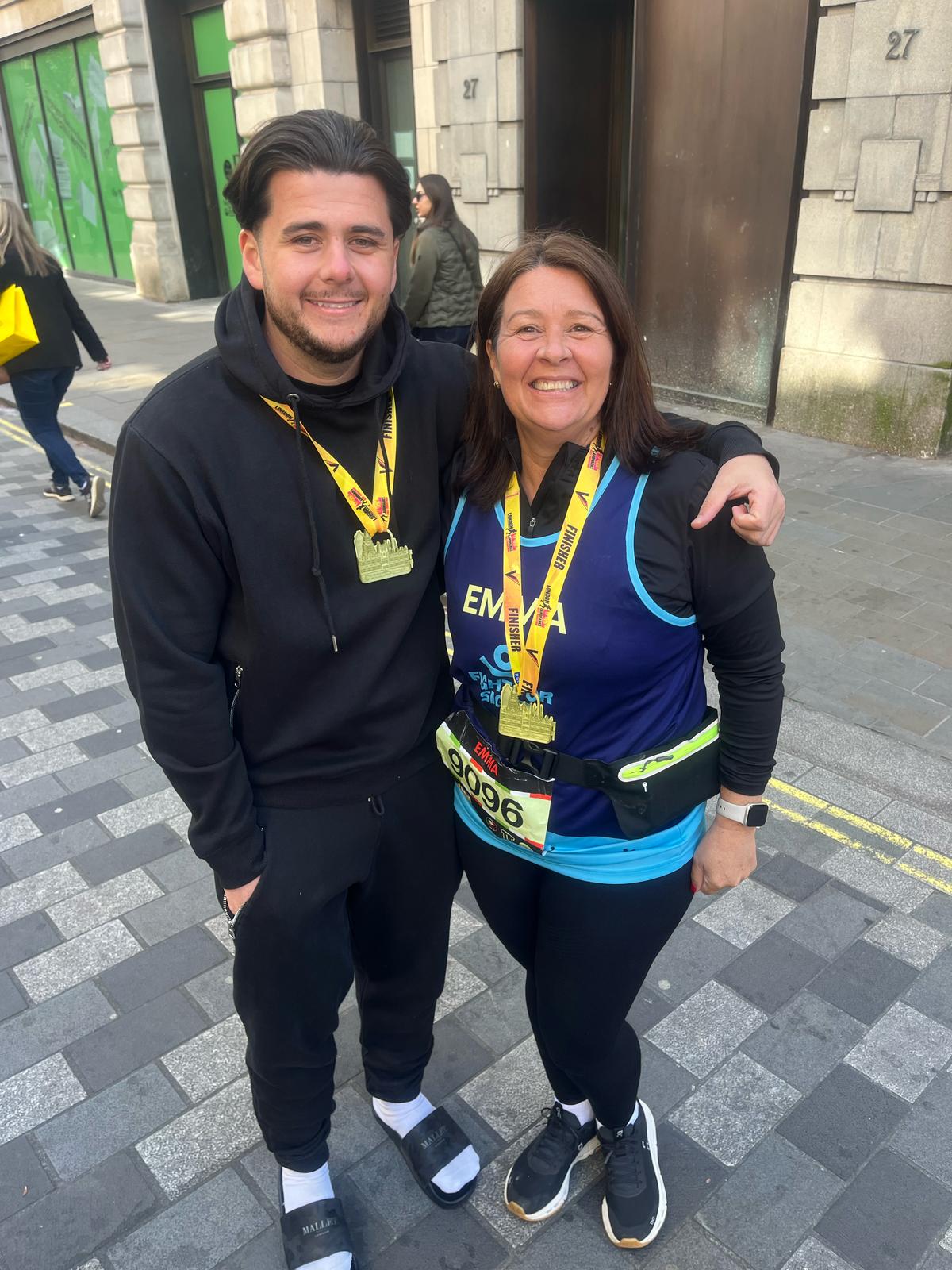 Emma and Tommy Salisbury who took part in the London Landmarks Half Marathon to raise money for Fight for Sight, celebrating with their medals on