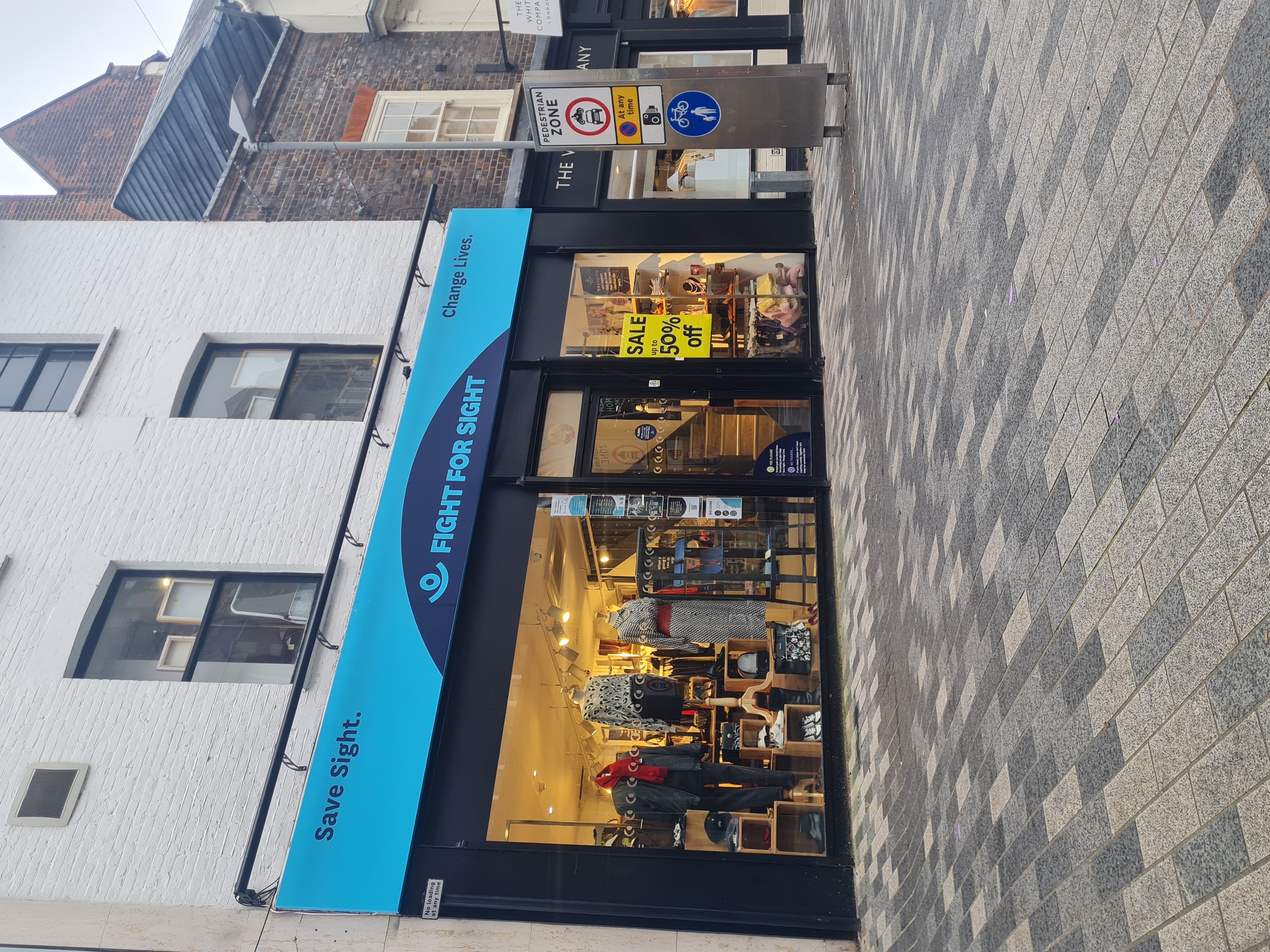 Kingston Fight for Sight Charity Shop, a turquoise exterior with our navy logo and the words Save Sight. Change Lives.