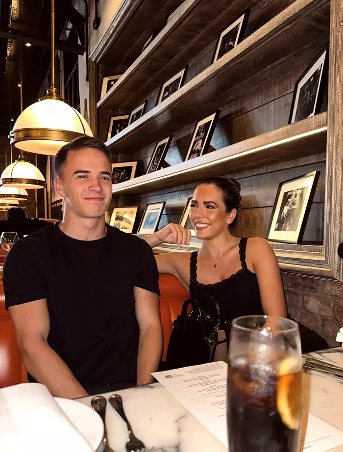 James and Gemma Owen sitting in a booth at a restaurant.