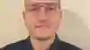 A headshot of Anastasios, a white man with short brown hair and glasses. He's lightly smiling at the camera.