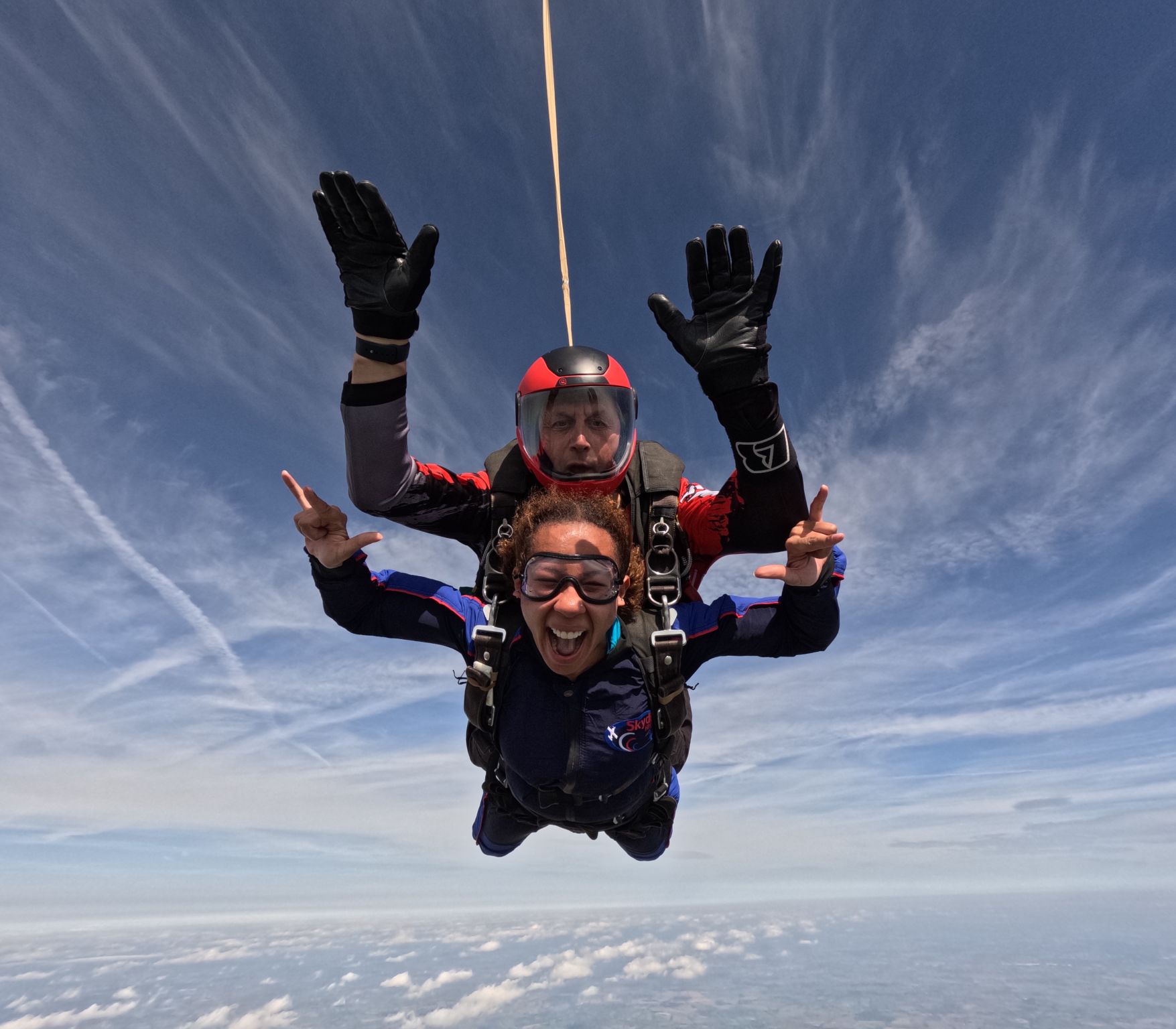 A Fight for Sight supporter smiling while freefalling during a tandem skydive