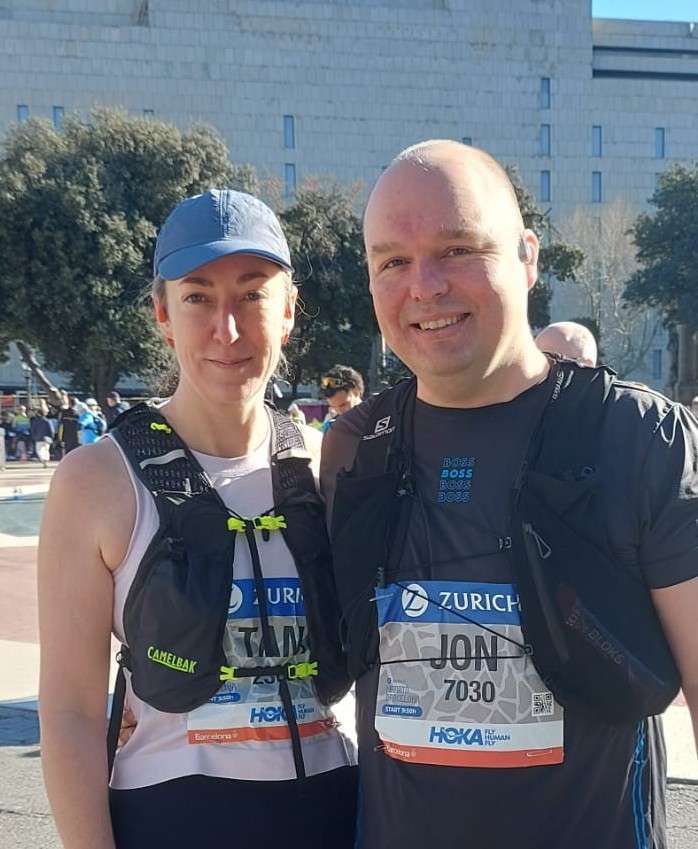 A couple posing together in running gear.