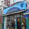 Muswell Hill Fight for Sight Charity Shop, a turquoise exterior with our navy logo and the words Save Sight. Change Lives.