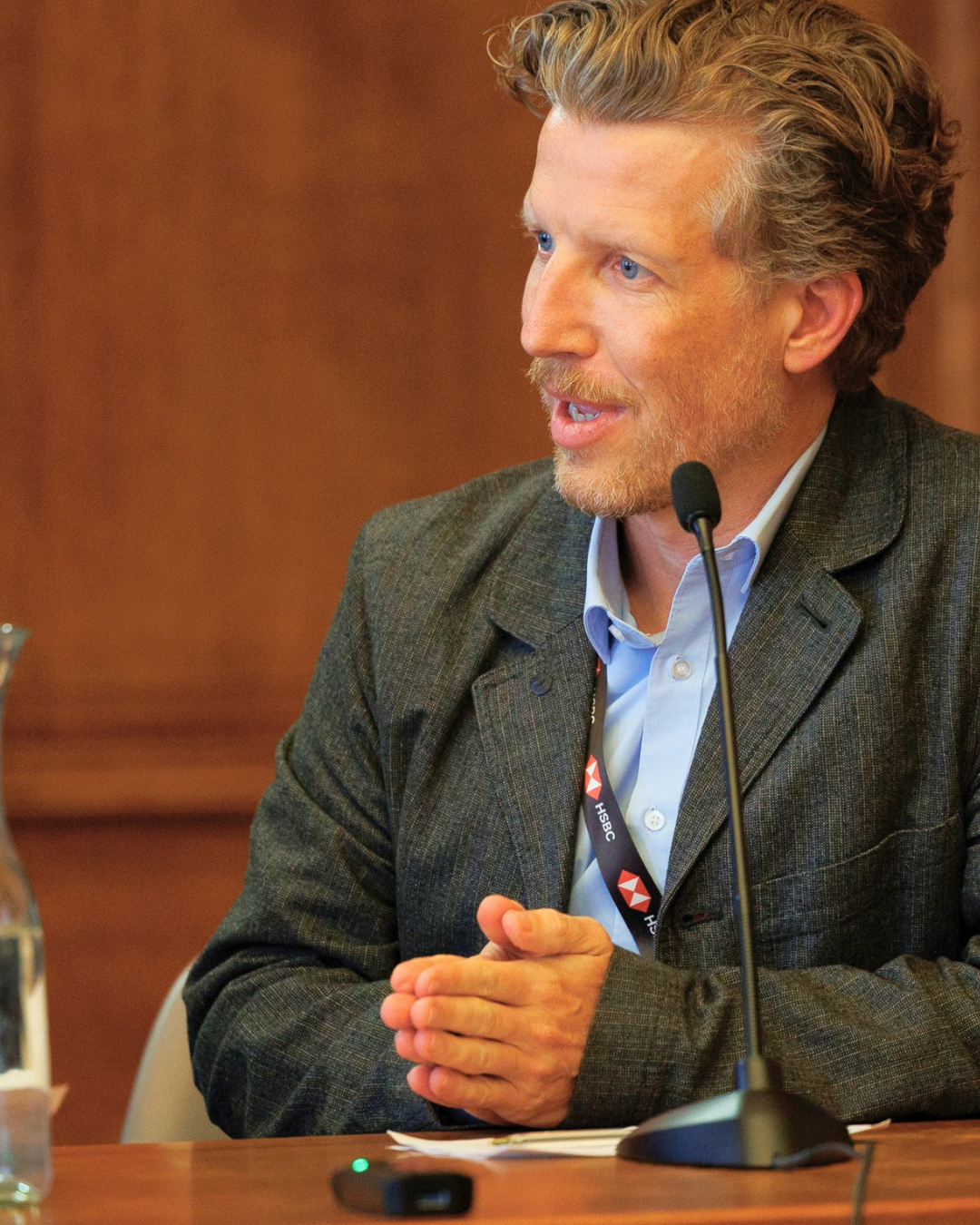 Josef Huemer Consultant ophthalmologist and Vis-Ability panellist for Fight for Sight he is shown in a suit talking into a microphone