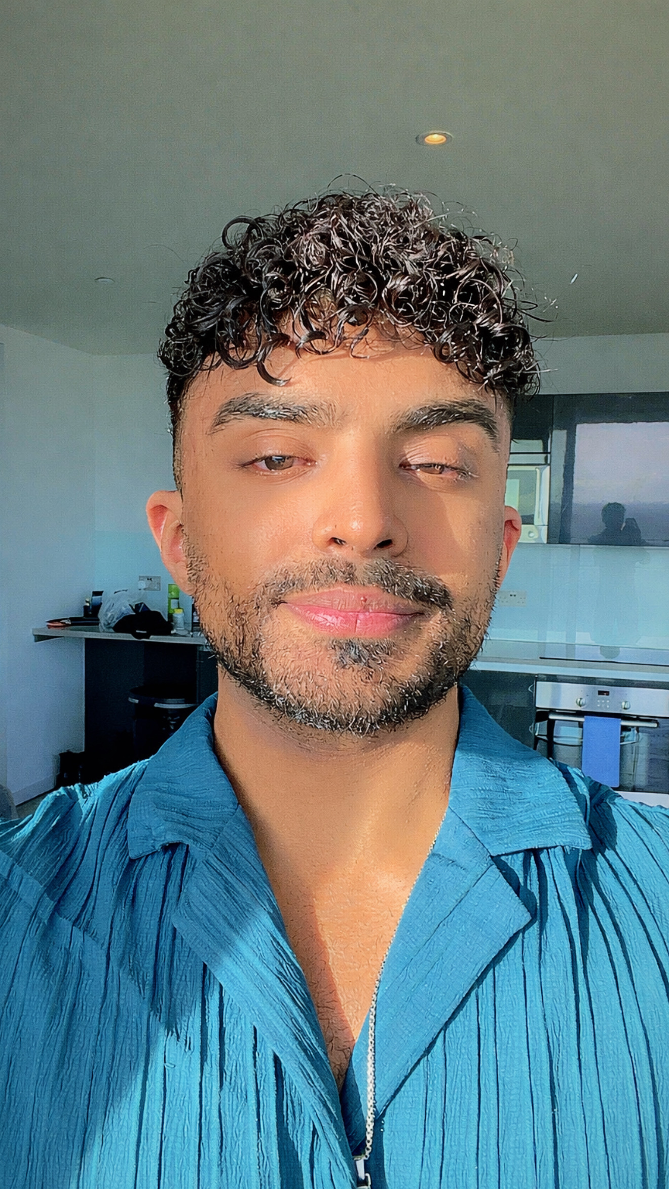 A picture of Ibraheem Iqbal in a bright blue shirt