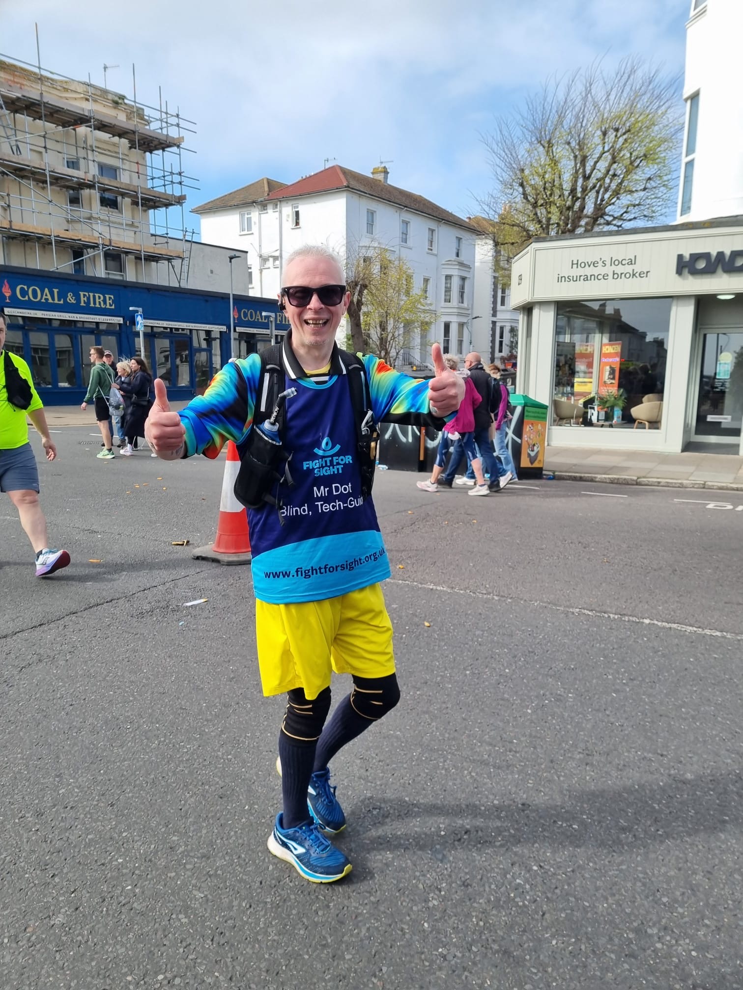 A Fight for Sight supporter smiling and giving the thumbs up while taking part in the Brighton Marathon