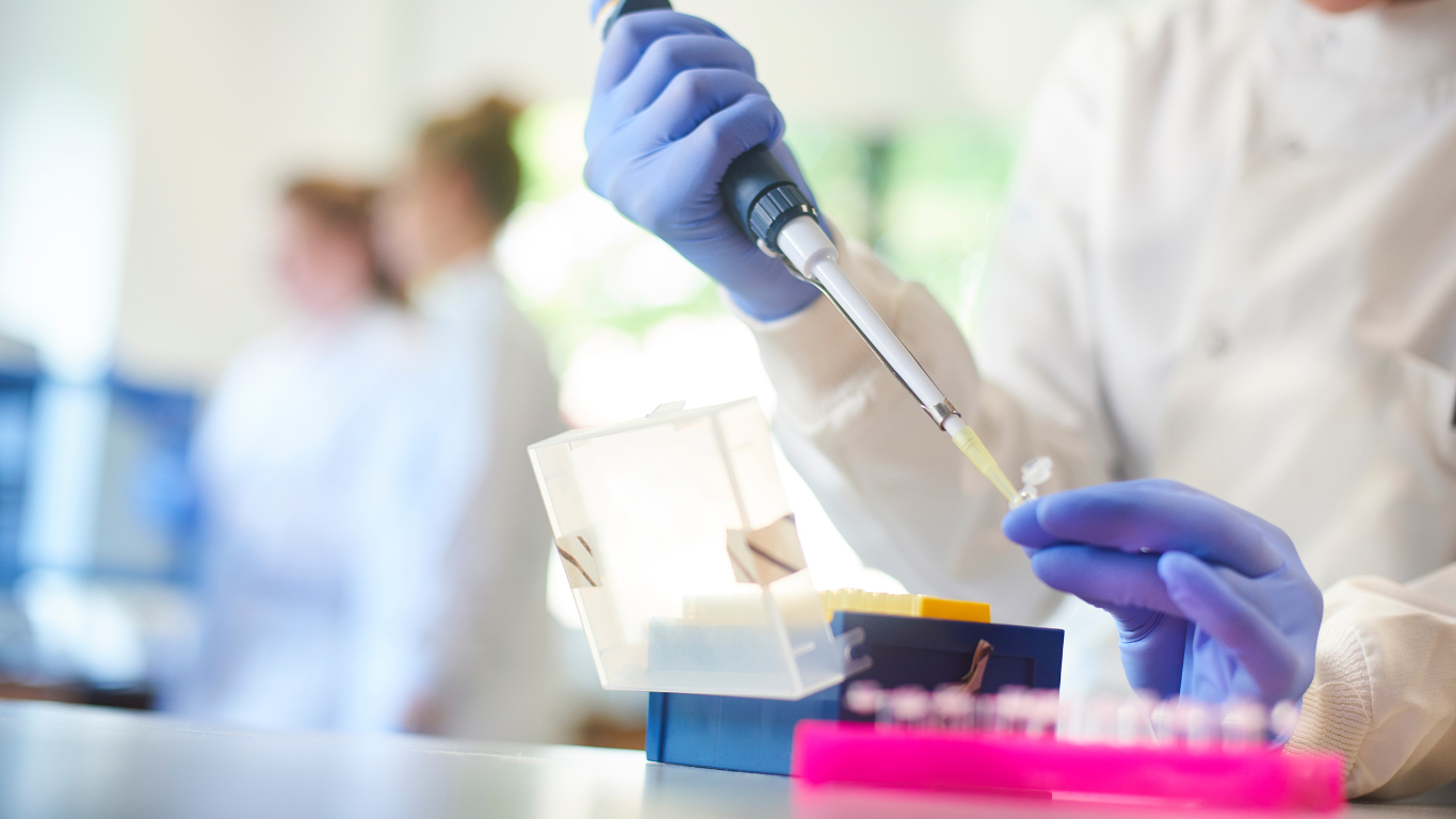 Researcher using a pipette in the lab
