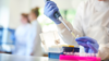 Researcher using a pipette in the lab