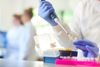 Researcher using a pipette in the lab