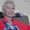 Elizabeth Maxwell in a red blouse and blue scarf