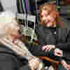 Tilly 'The Blind Stylist' from Wanted Wardrobe and Elizabeth Maxwell are sat chatting, Tilly is laughing and has her hand on Elizabeth's arm