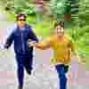 Avi Krishnan and his brother Aarav running. Avi wears tinted glasses as he is photophobic due to his achromatopsia