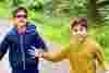Avi Krishnan and his brother Aarav running. Avi wears tinted glasses as he is photophobic due to his achromatopsia