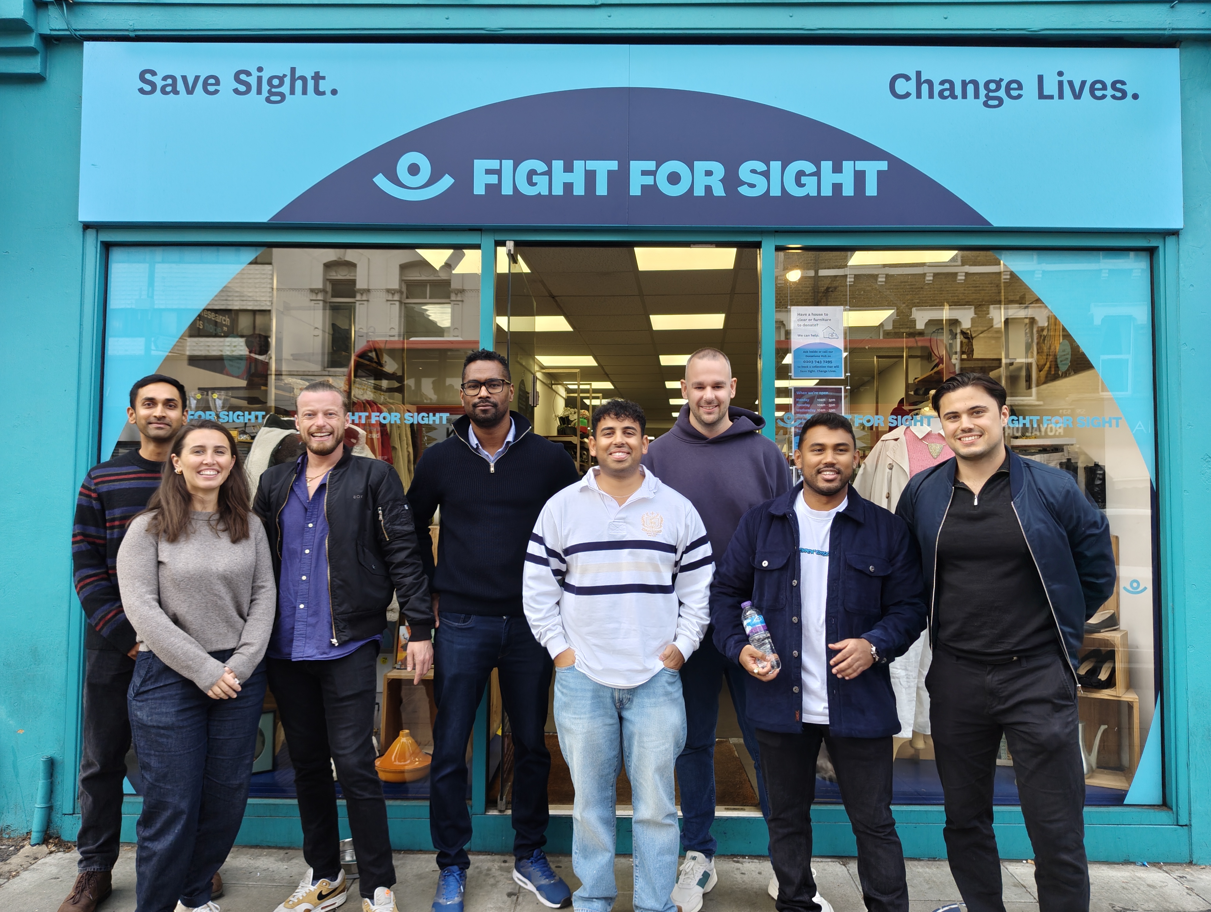 Turner & Townsend Corporate Volunteers smiling outside Fight for Sight Tulse Hill Charity Shop