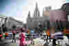 Runners taking part in the Barcelona Marathon and passing the Sagrada Familia