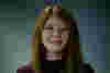 Rebecca is a young white woman with long red hair. She is smiling for the camera. 