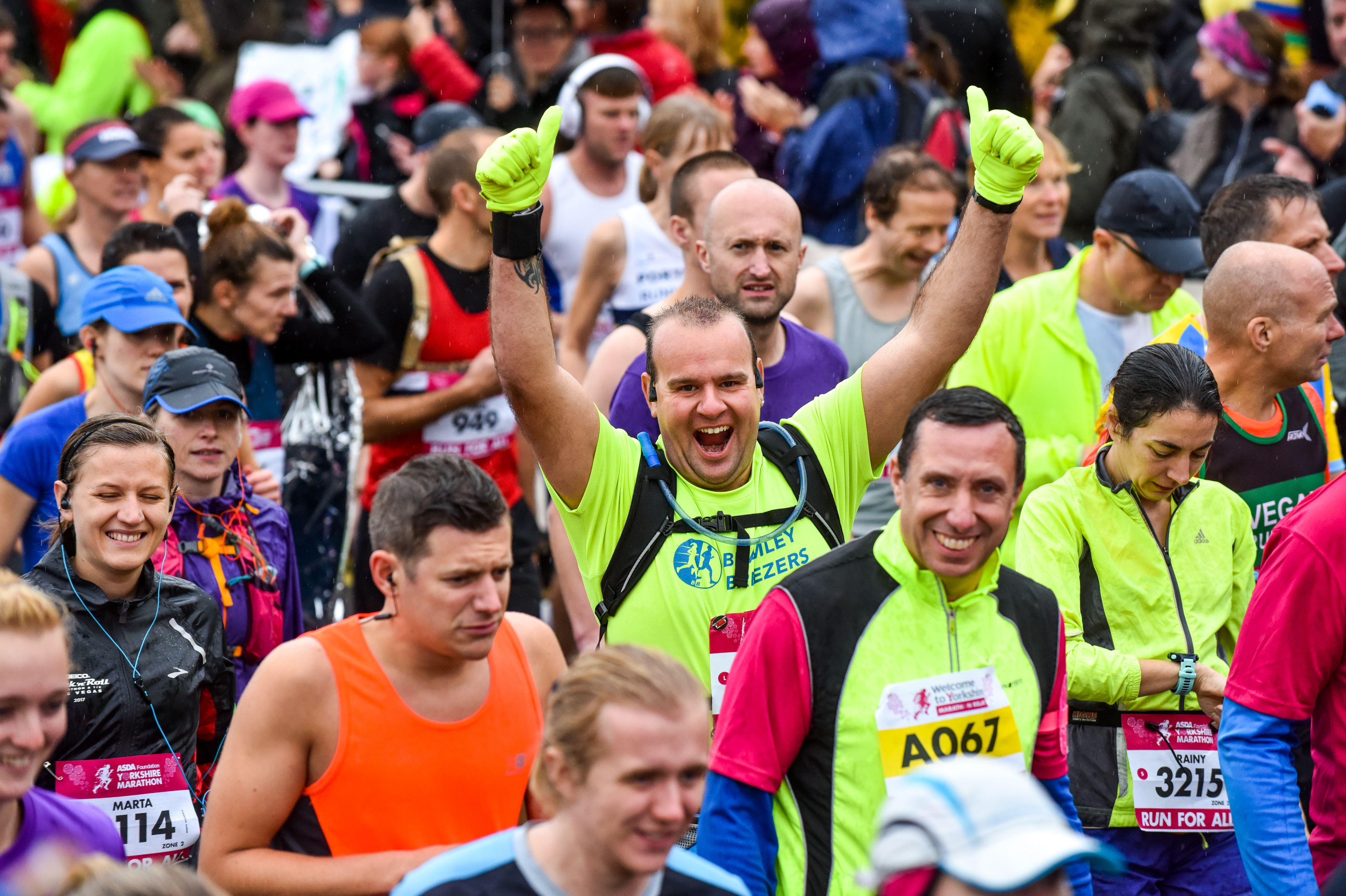 Runners waving while taking part in the Yorkshire Marathon