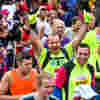 Runners waving while taking part in the Yorkshire Marathon