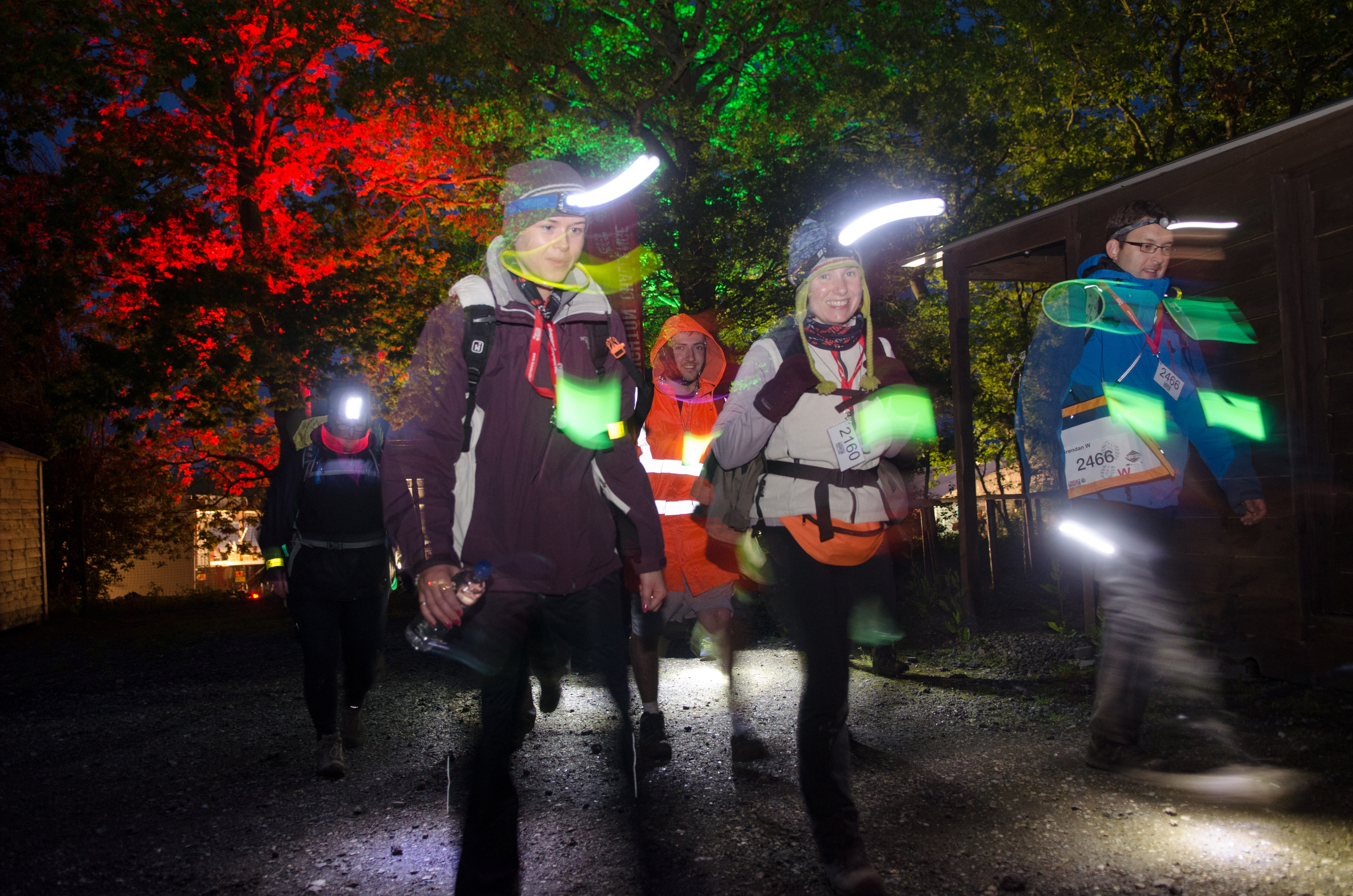 People taking part in the Halloween Walk in a dark night with illuminated clothing and lights