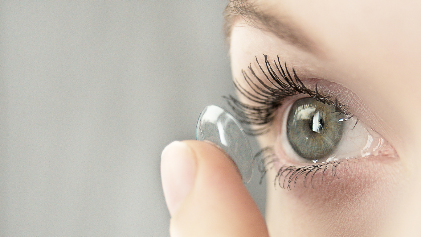 Person putting in contact lens
