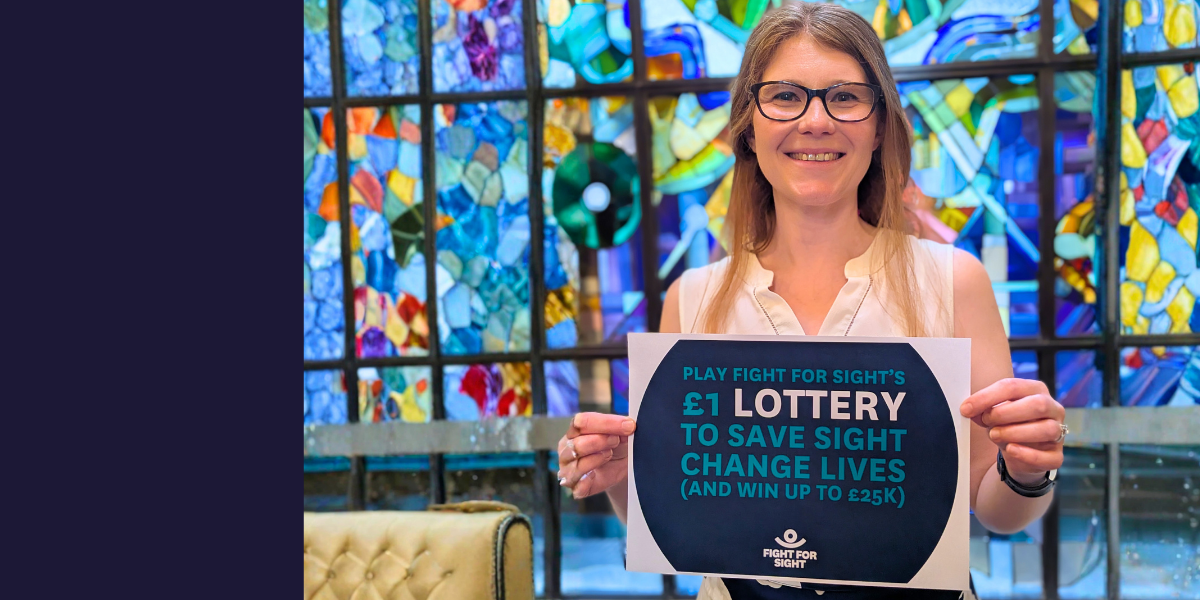 A woman holding up a sign for the Fight for Sight lottery