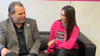 Keith Valentine and Gemma Owen sitting on a sofa.