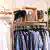 Clothing rail in our charity shop in Kensington with a selection of blue shirts