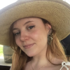 A photo of Lauren in a wide-brimmed straw hat.