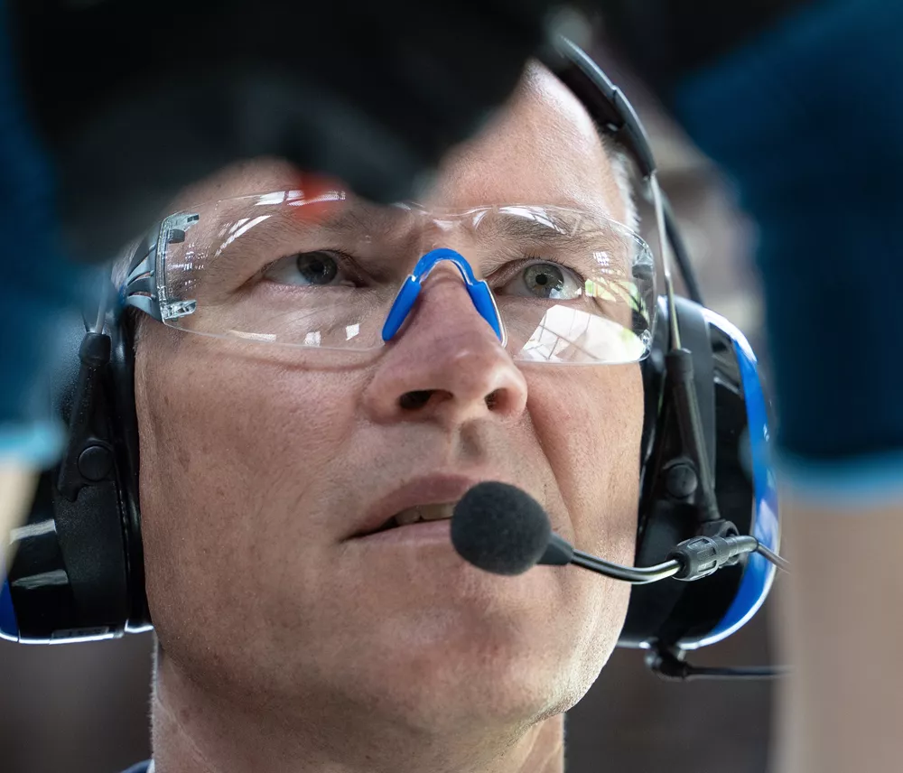 A man wearing safety goggles and ear protectors.