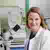 Alice Davidson in a lab with a white lab coat.