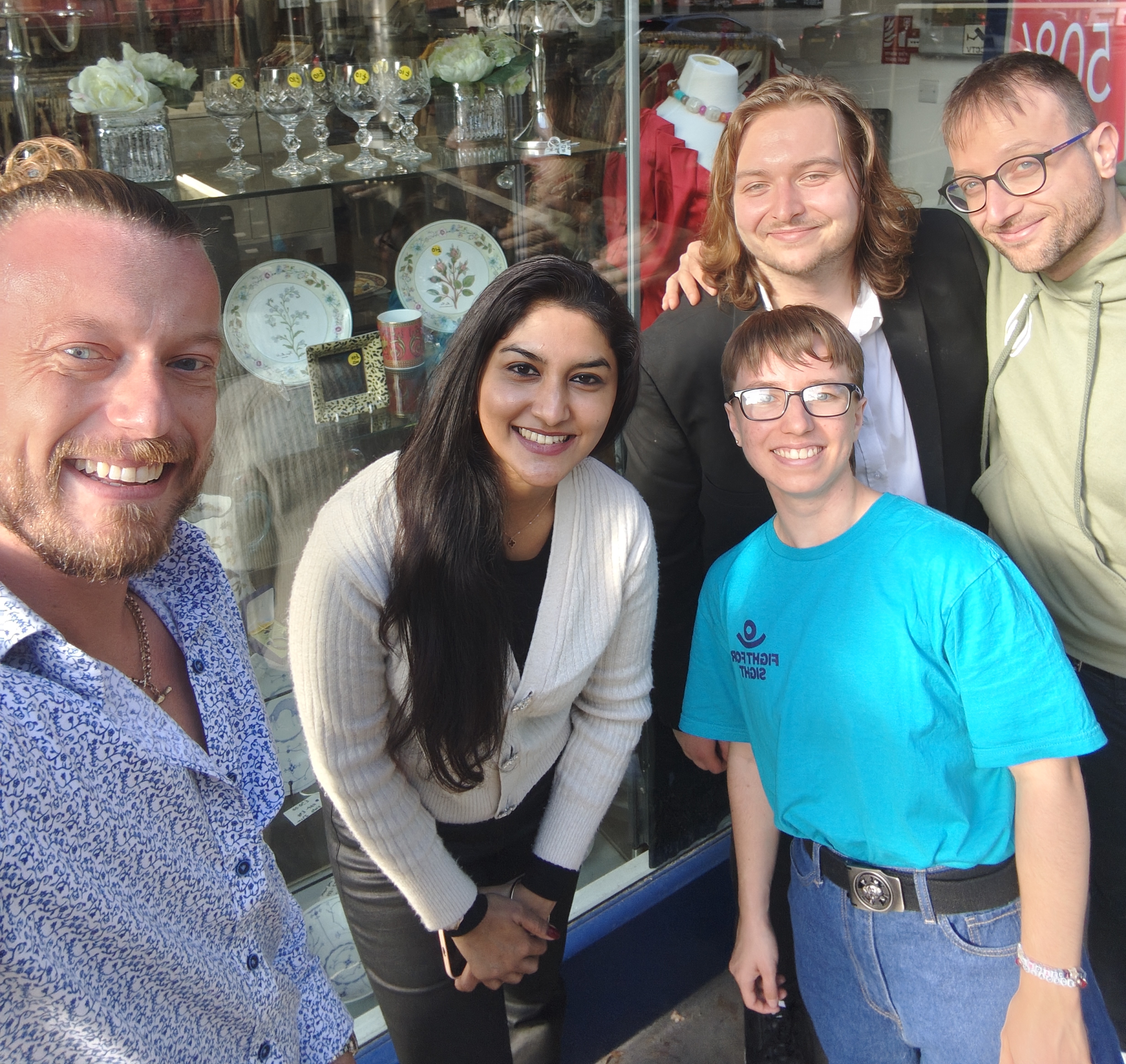 Fight for Sight Corporate Volunteering a group of people smiling outside our Kensington Charity Shop