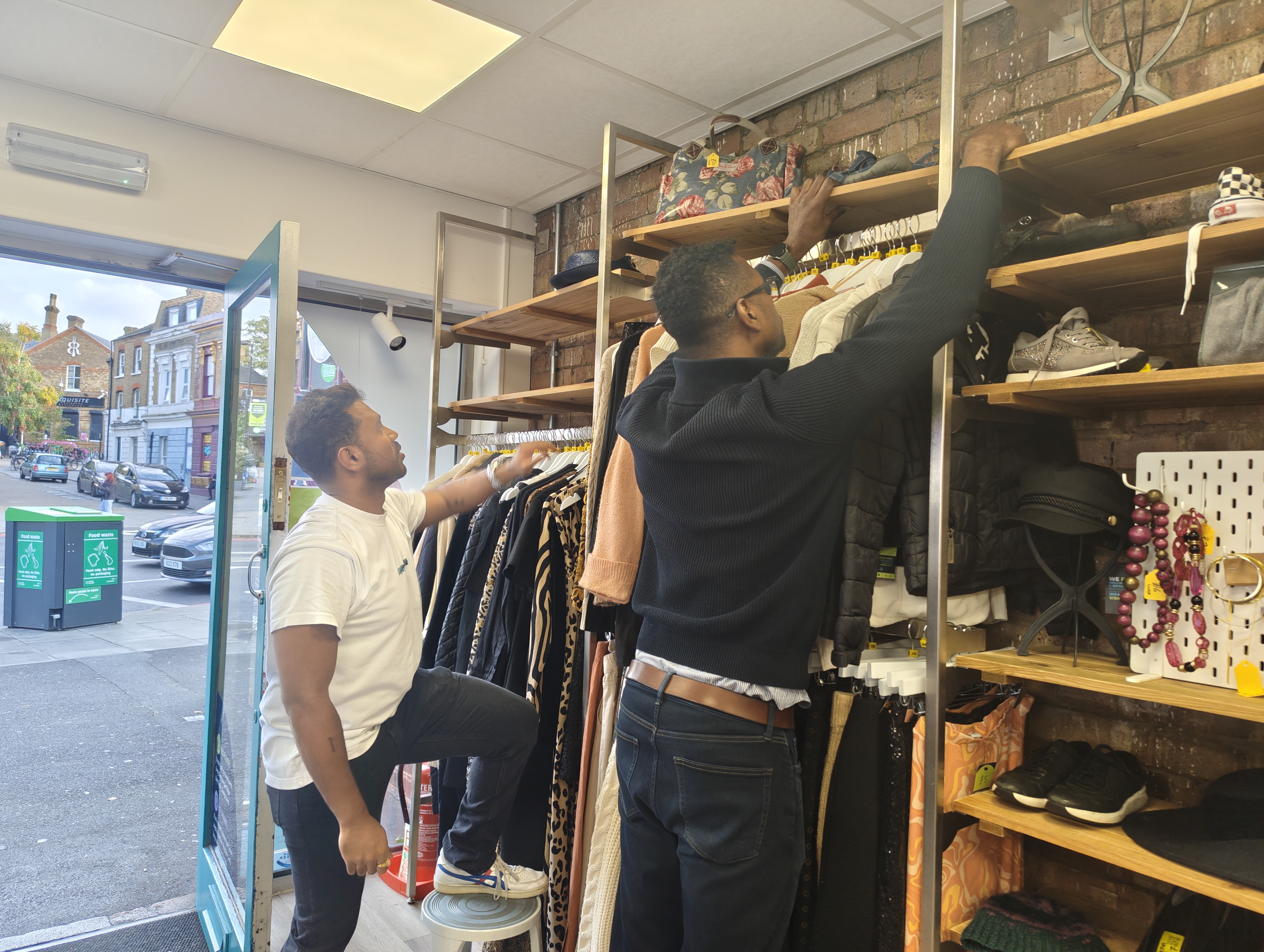 Two young men putting up a shelf in Tulse Hill.