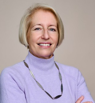 A photo of Georgie Stewart with her arms folded.