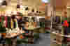 Inside one of our charity shops, there are a few people browsing at the clothing and homeware on sale