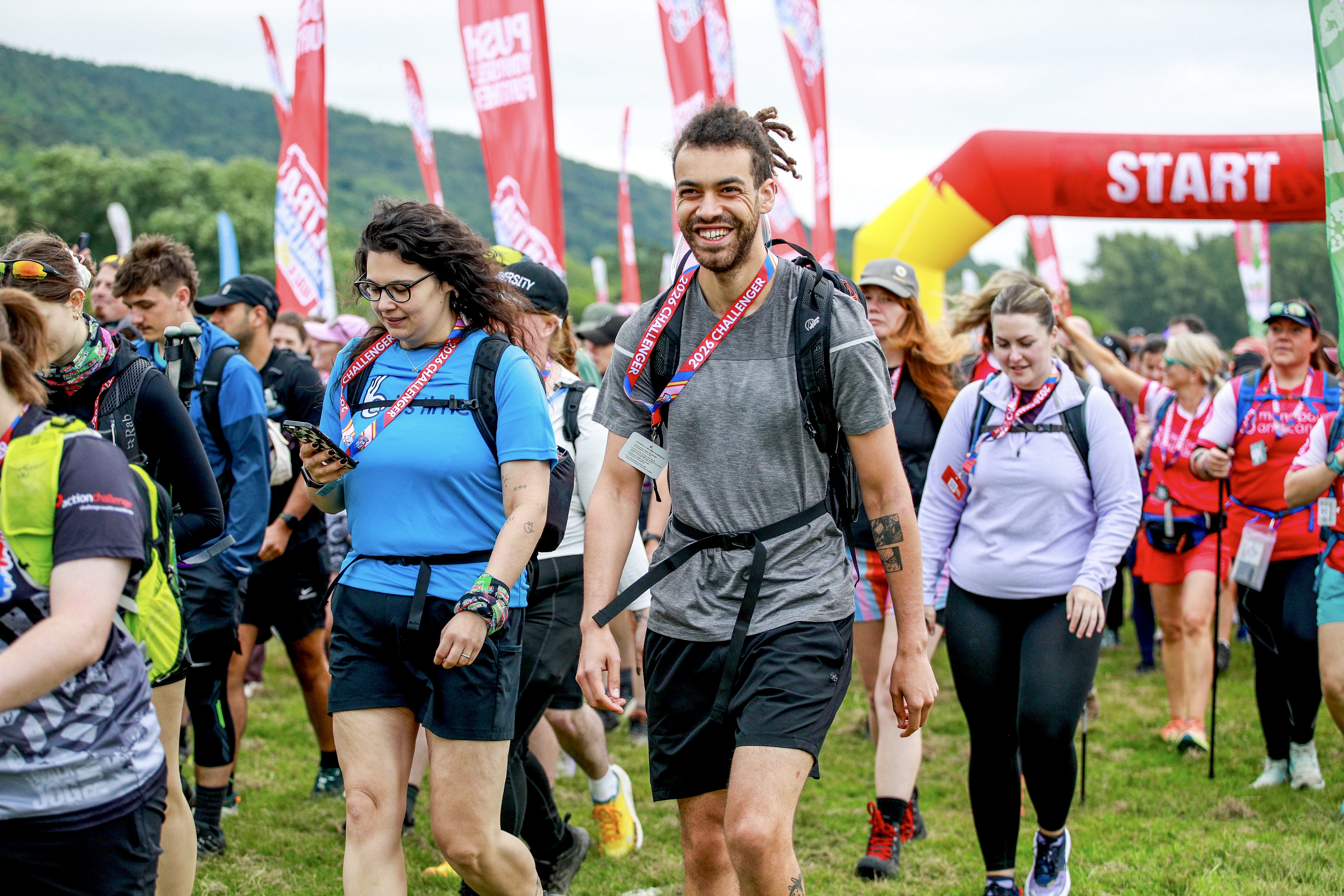 Walkers smiling after crossing the start line of the Peak District Ultra Challenge